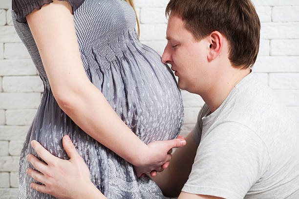 istock Beautiful young couple expecting baby 472141420