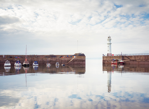 The lighthouse on the harbour walls of Newhaven harbour, part of Edinburgh's waterfront along the Firth of Forth.