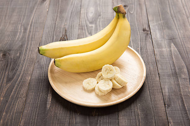 istock Fresh bananas on wooden background 472141984