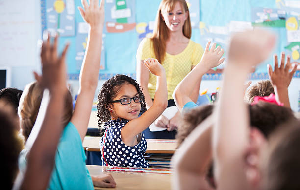 istock Hispanic girl raising hand in class 472142427