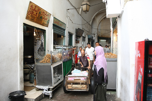 Tunis,Tunisia - September 14th, 2012 :  People walking around fast food store in the Medina, famous marketplace in Tunis, Tunisia.