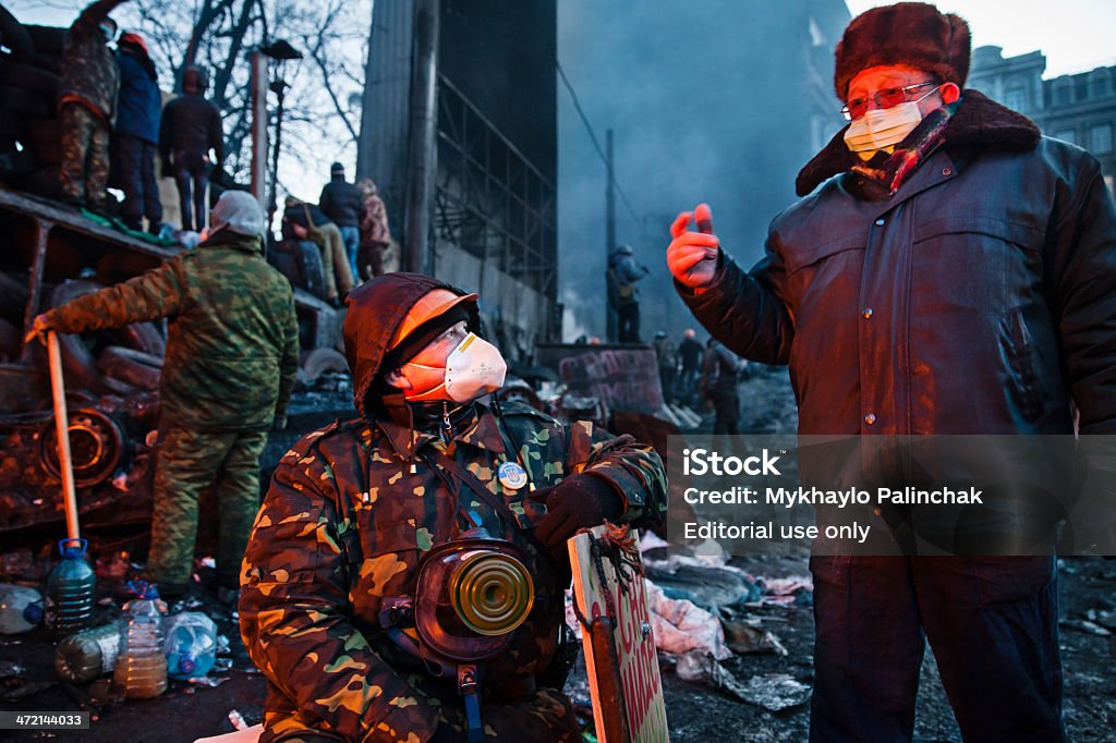 KIEV, UKRAINE - January 26, 2014: Euromaidan protesters rest and KIEV, UKRAINE - January 26, 2014: Euromaidan protesters rest and strengthen their barricades on Hrushevskoho Street after another night of clashes with riot police in Kiev, Ukraine. Armed Forces Stock Photo