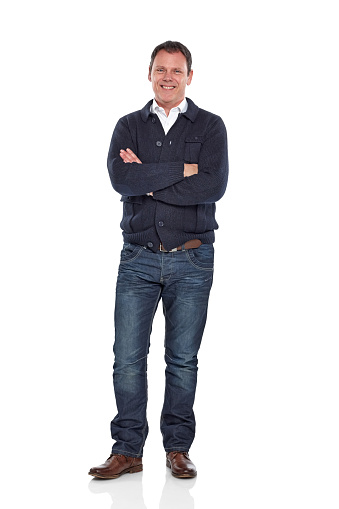 Full length portrait of attractive middle aged guy standing with his arms crossed over white background