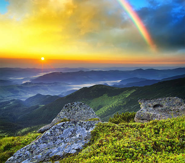 istock Mountain landscape with a rainbow in the sky during sunset 472144292