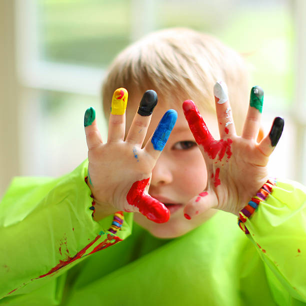 istock Child With Colorful Paint on His Hands 472144970