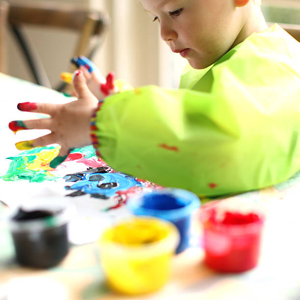 istock Child Painting with Fingerpaint 472144974