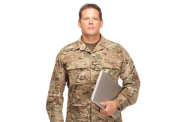 istock U.S. Army Soldier, Sergeant. Isolated and serious with laptop. 472145070