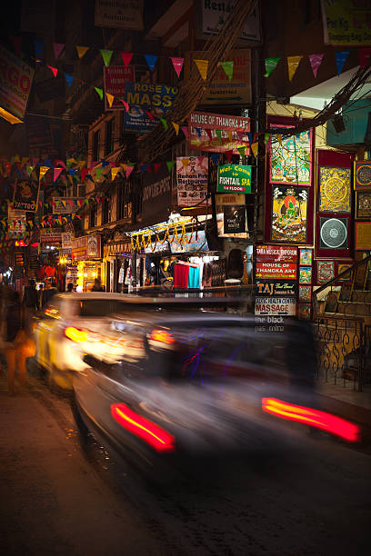 Night Thamel Kathmandu, Nepal - November 17th, 2013: Cars drive along main tourist and market street of Thamel street racing stock pictures, royalty-free photos & images