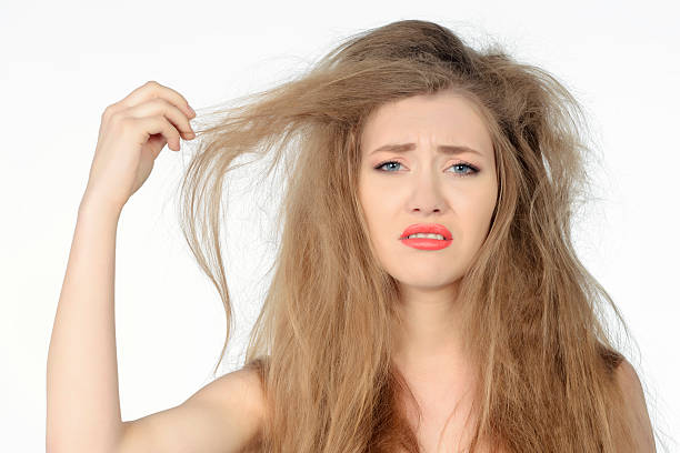 bad hair day woman expressing negativity sad woman expressing negaitivity having a bad hair day. dry hair stock pictures, royalty-free photos & images