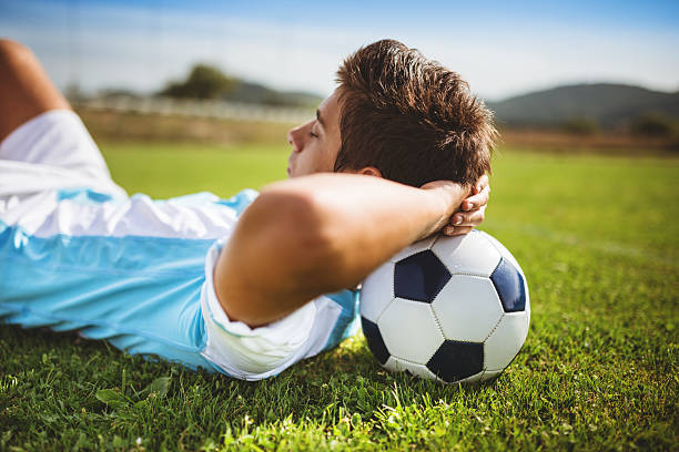 istock Soccer player resting on the field 472147059
