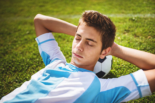 istock Soccer player resting on the field 472147069