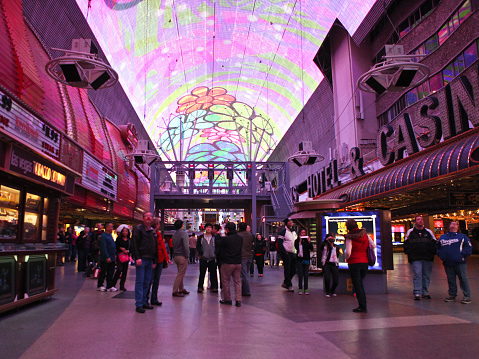 Las Vegas, USA - December 19, 2013: A part of the giant screen roof  over  Fremont  Street  Experience  in Old Las Vegas.  The  famous Fremont Street Experience   is a pedestrian mall covered with a giant barrel vault canopy that is illuminated at night with visual and musical shows. This night shot shows a part of this giant screen and tourists looking at the show.