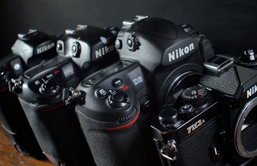 Philadelphia, PA, United States - June 10, 2012: Four generations of Nikon SLR cameras. Seen from left to right are: D80, D2X, D3X digital SLR cameras and an analogue FM3a. 