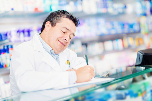 Man at the pharmacy behind the counter