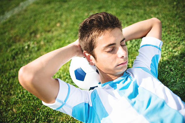 istock Soccer player resting on the field 472149955