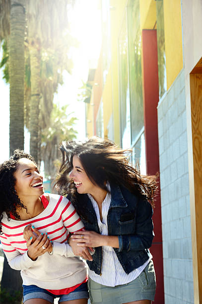 istock Two young women out shopping, having fun 472150569