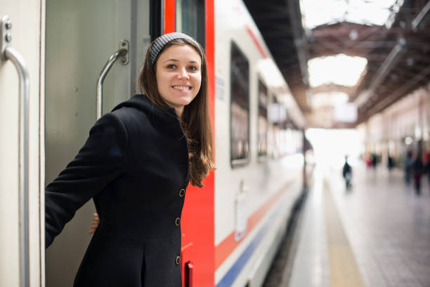 istock Happy young woman traveling with train 472151067