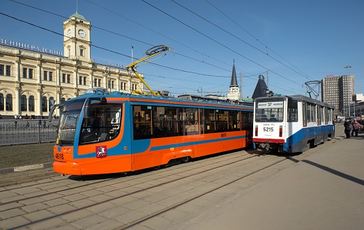 Moscow, Russia - March 19, 2015: Modern trams in Moscow on a background of Leningradsky railway. Komsomolskaya Square