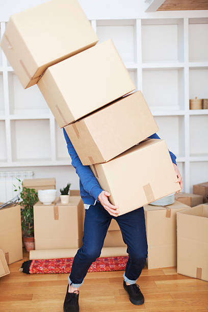 istock New beginings, man unpacking at home. 472152263