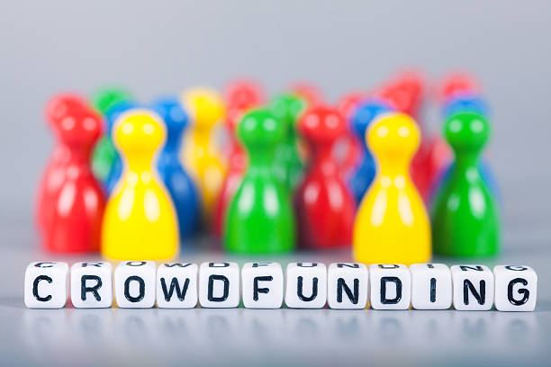 istock Cube Letters show crowdfunding  in front of unsharp ludo figures 472152556