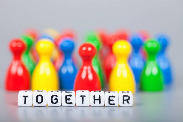 istock Cube Letters show together  in front of unsharp ludo figures 472152782