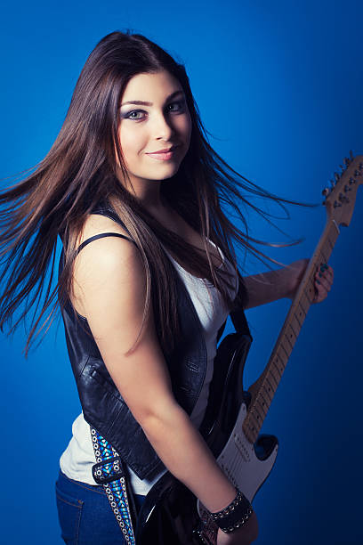 istock beautiful young woman with guitar 472153333