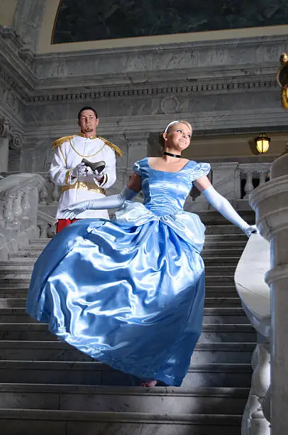 Cinderella and Prince Charming walking down staircase.  Prince holding slipper.