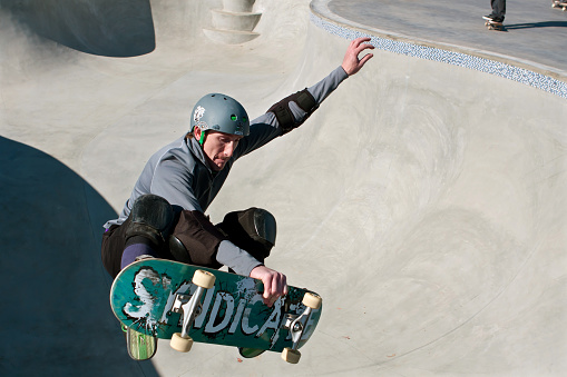 Kennesaw, GA, USA - November 24, 2013:  A veteran skateboarder catches air in the bowl during \