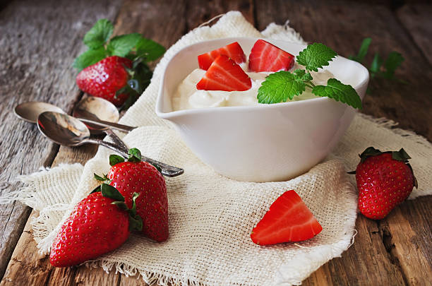 istock yogurt and ripe strawberries 472155310