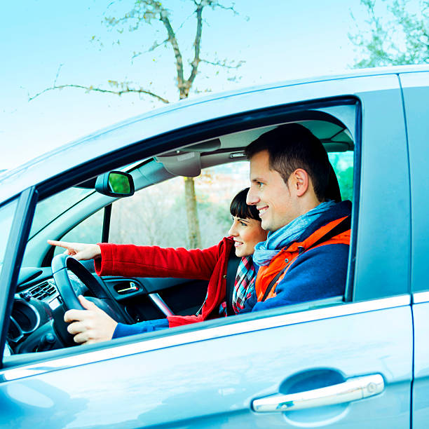 istock Casual couple driving in winter 472155321