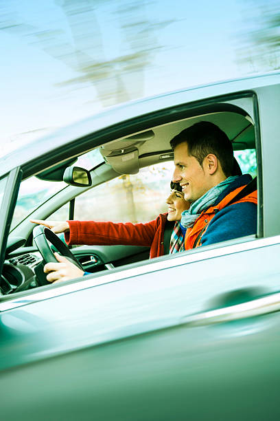 istock Casual couple driving in winter 472155375