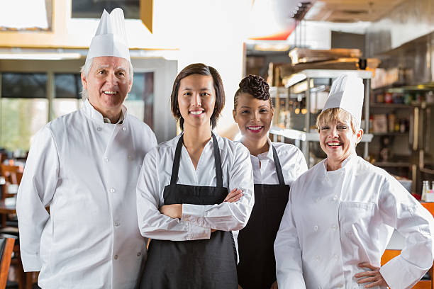 istock Team of chefs and waiters in modern restauarant kitchen 472155673