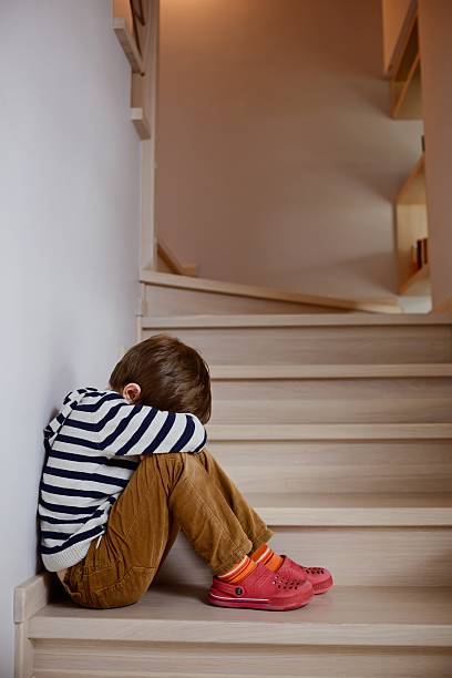 istock Sad little boy crying depressed sitting 472155820