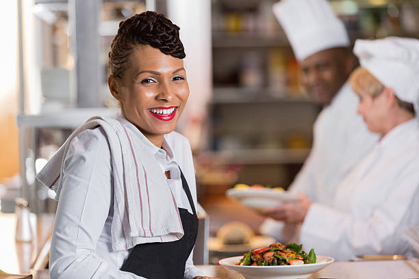 istock Pretty waitress in restaurant commercial kitchen with customer's order 472155977