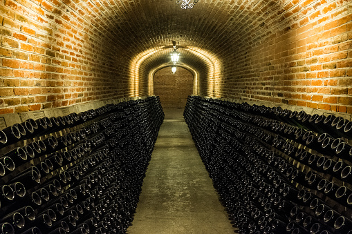 Picture of a beautifully constructed red brick wine cellar. Sparkling wine or cava is stored in places like this one.