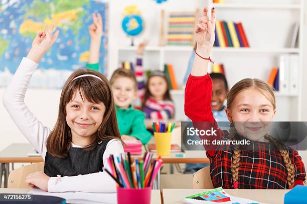 School Children With Raised Hands In Classroom Stock Photo - Download Image Now - Classroom, Learning, Child