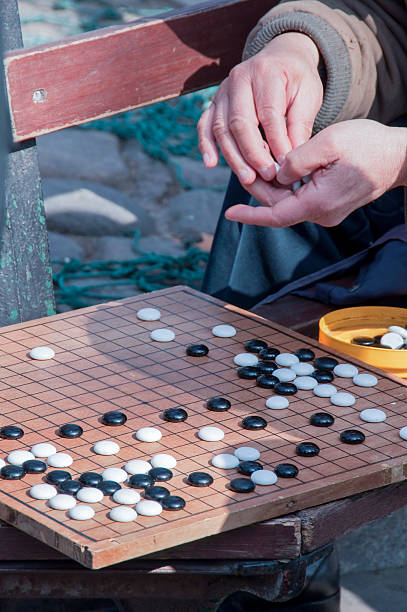 istock People playing chinese chess (go), on a bench, Shanghai, China 472156366