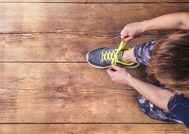 istock A runner tying up her laces, shot from above 472156492