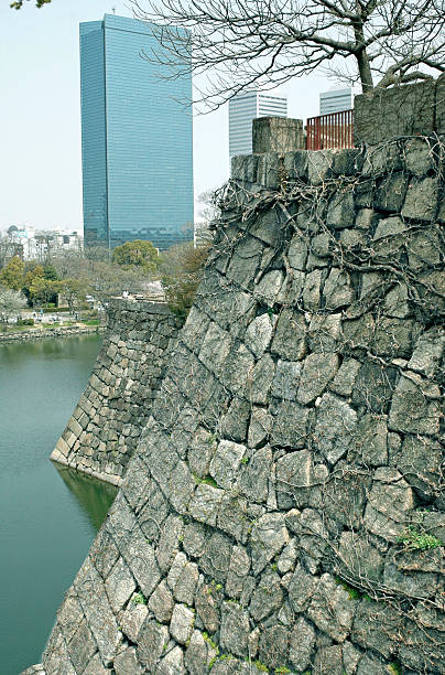 istock Old stone wall and skyscraper in Osaka JPN 472156502