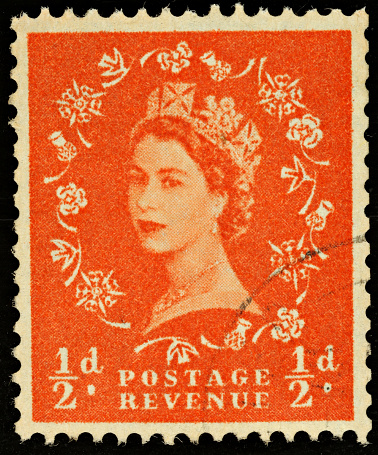 Exeter, United Kingdom - February 1, 2010: British Half Pence Orange Used Postage Stamp showing Portrait of Queen Elizabeth 2nd, printed and issued from 1952 to 1965