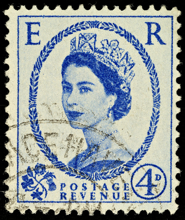 Exeter, United Kingdom - February 1, 2010: British Four Pence Blue Used Postage Stamp showing Portrait of Queen Elizabeth 2nd, printed and issued from 1952 to 1965