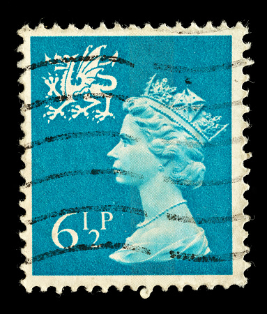 Exeter, United Kingdom - February 17, 2010: A Welsh Used Postage Stamp showing Portrait of Queen Elizabeth 2nd and welsh dragon, printed and issued from 1971 to 1992