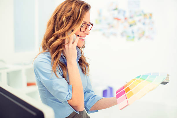 istock Female Designer Talking On The Phone At Work. 472156849