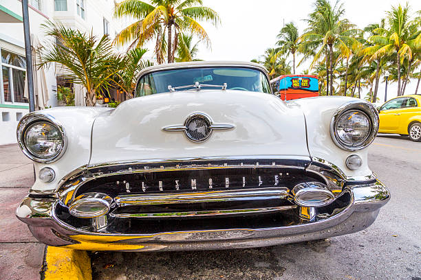 Miami, USA - July 30, 2013: classic Oldsmobile with chrome radiator grill parked in front of the restaurant in Hotel Avalon in Miami Beach, Florida.