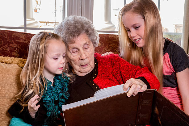 istock Elderly Woman and Girls Reading 472158489