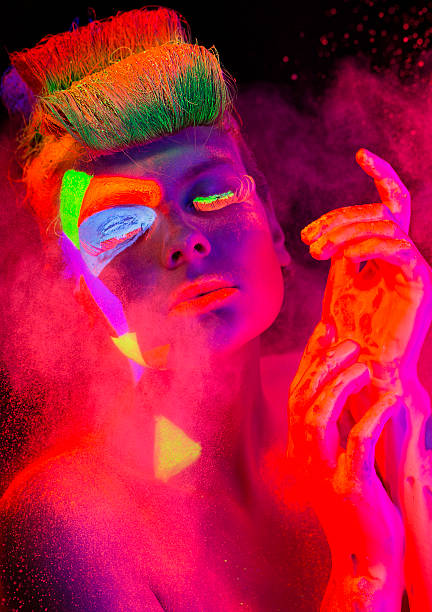 istock Women Portrait with Glowing makeup in black light 472160343