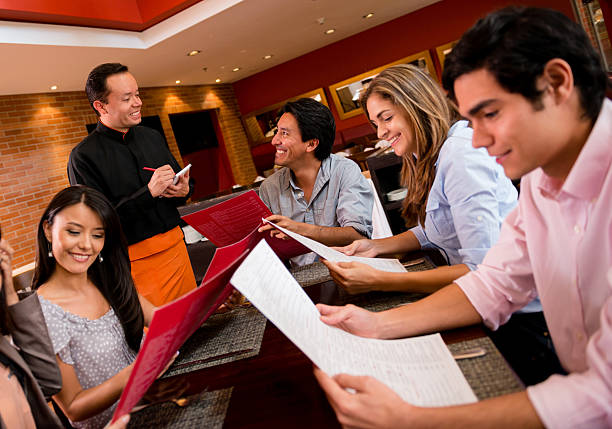 istock Group of friends at a restaurant 472160541