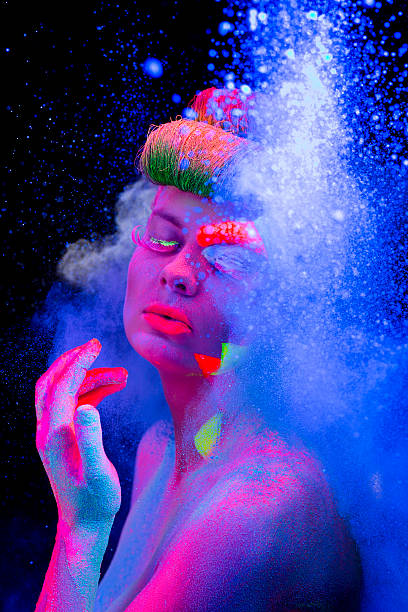 istock Women Portrait with Glowing makeup in black light 472160699