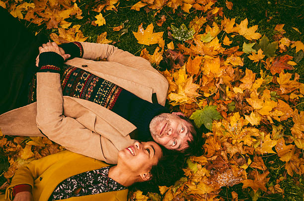 istock Couple Lying Down On Yellow Leaves 472161119