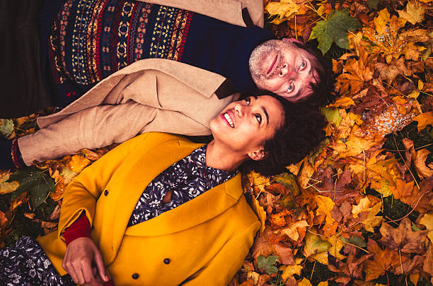 istock Couple Lying Down On Yellow Leaves 472161123